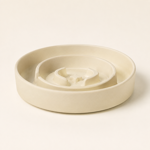 Beige ceramic Bupba Slow Feeder bowl in a studio setting